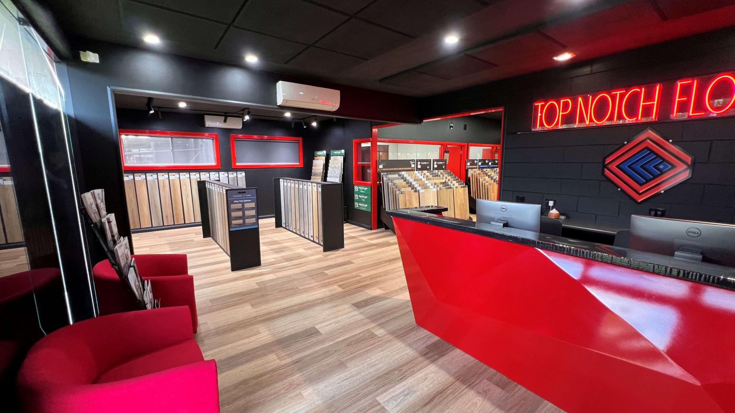 Open display of a modern luxury flooring showroom showing vinyl planks, hybrid, timber flooring.