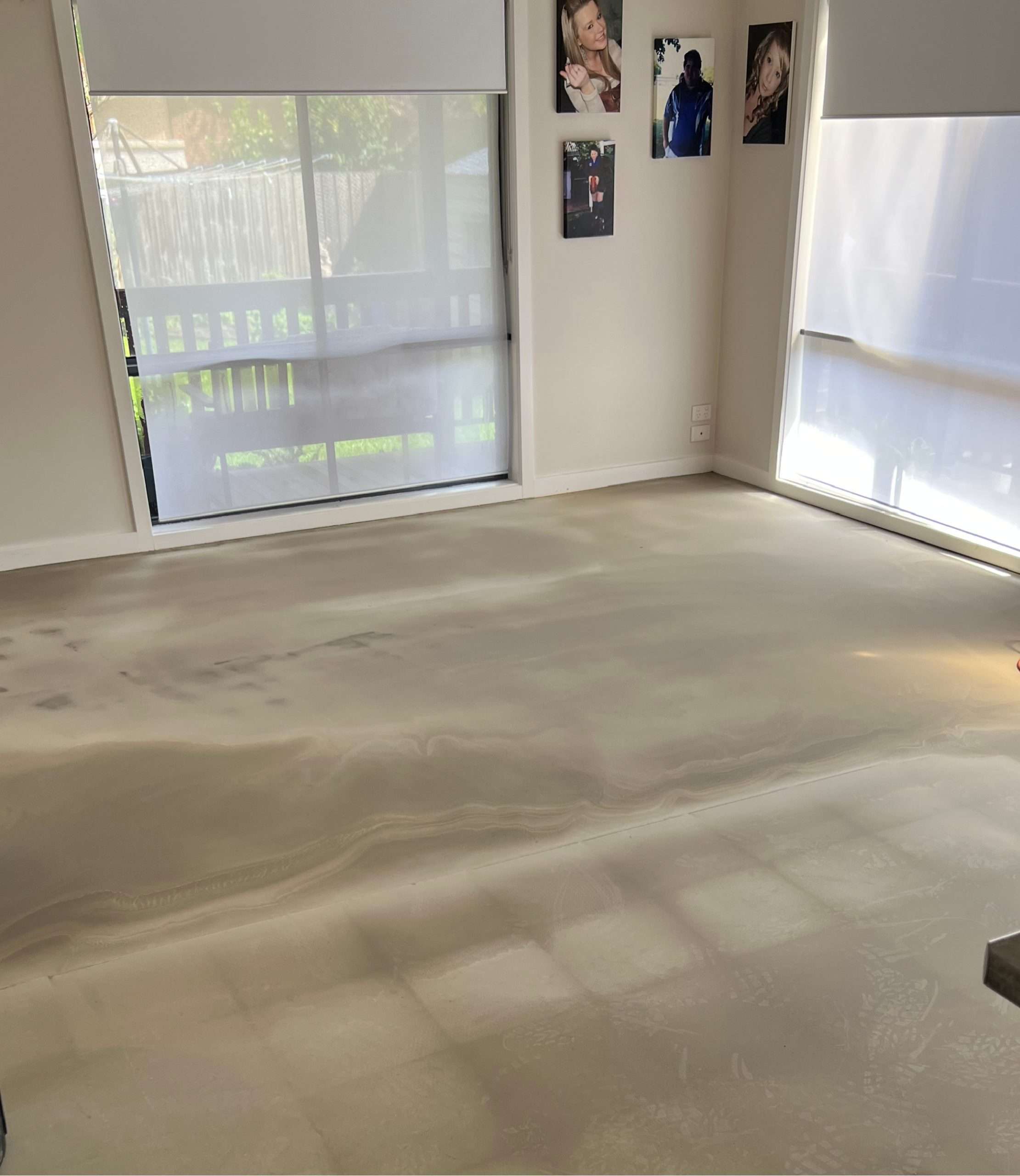 The floor after having a floor leveler poured in preparation for vinyl planks.