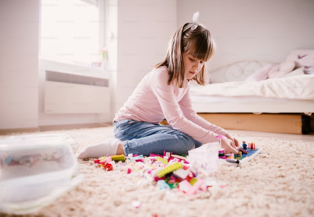 Young child playing happily on plush soft carpet flooring in a Gippsland home, ideal for family homes with kids